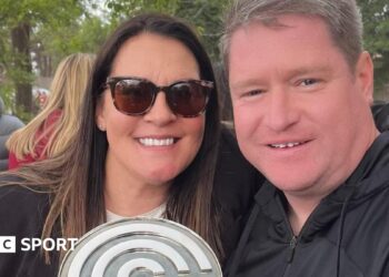 Liverpool Women manager Matt Beard and his wife Debbie smile while celebrating the Reds' Championship title win