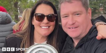 Liverpool Women manager Matt Beard and his wife Debbie smile while celebrating the Reds' Championship title win