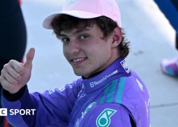 Mercedes' Kimi Antoenlli looks back, smiles and gives the thumbs-up signal after taking pole position for the Miami Grand Prix