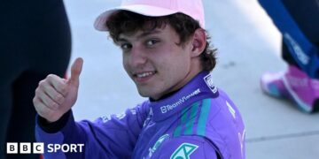 Mercedes' Kimi Antoenlli looks back, smiles and gives the thumbs-up signal after taking pole position for the Miami Grand Prix