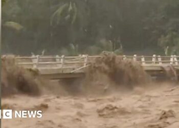 Moment Indonesian river overflows from heavy rain