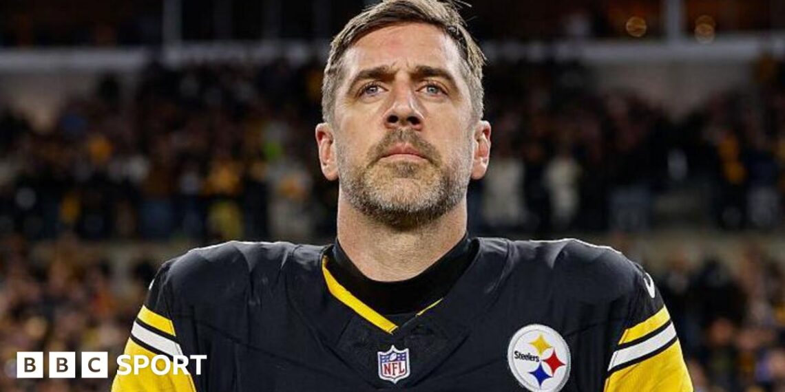 Aaron Rodgers looks on during the national anthem before his Pittsburgh Steelers team loses to the Houston Texans in the NFL play-offs in 2026