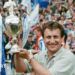 Neil Warnock holds up the play-off trophy at Wembley adorned with blue and white ribbons