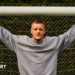 Jamie Vardy stood in a goal with his arms outstretched and holding onto the crossbar