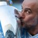 Pep Guardiola kisses the Premier League trophy