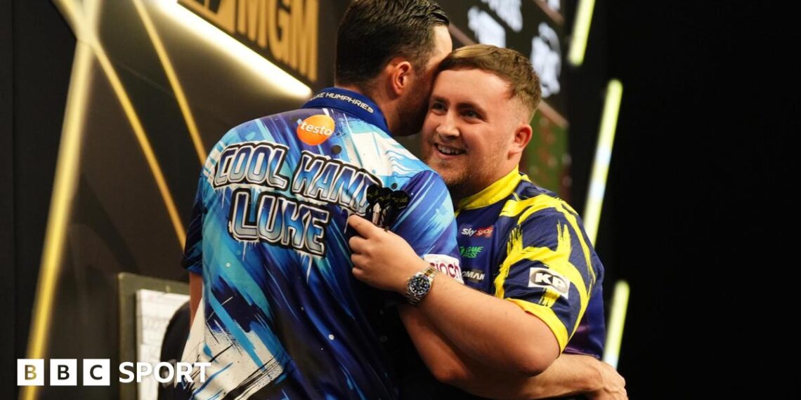 Luke Littler (right) embraces Luke Humphries after victory in the final on night thirteen of the BetMGM Premier League 2026 at P&J Live, Aberdeen.