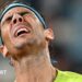 Rafael Nadal winces in pain.