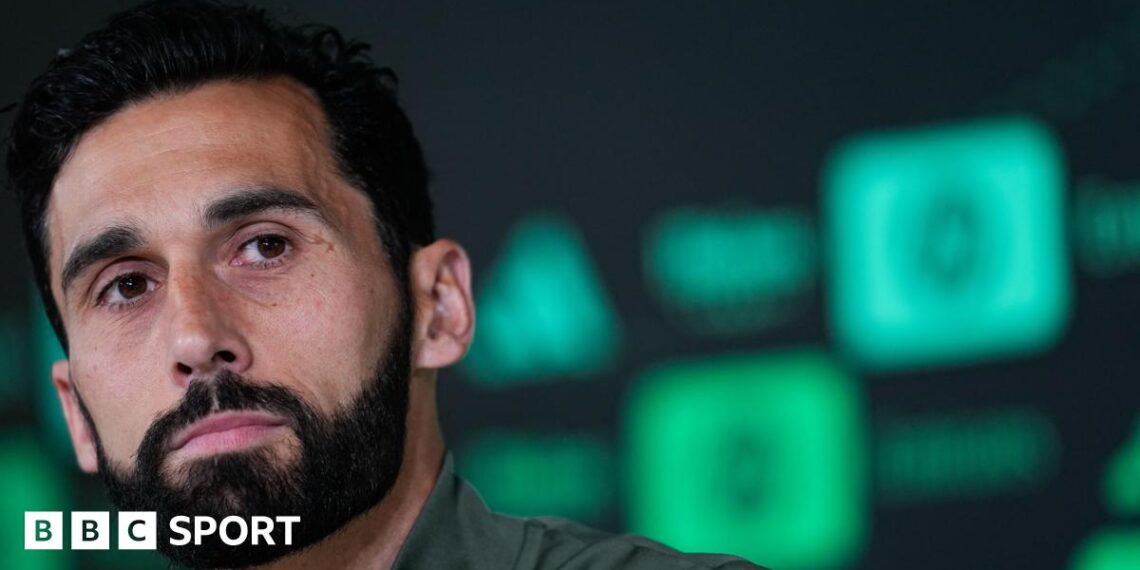 Close-up of Real Madrid head coach Alvaro Arbeloa, who has dark hair and beard and is wearing a green top