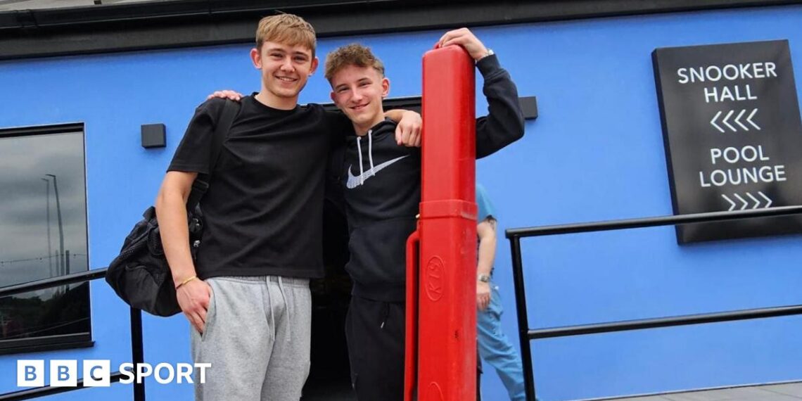 Two players pose for a picture outside the Norther Snooker Centre in Leeds