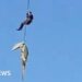 South African police officer lowered into crocodile-infested river to recover human remains