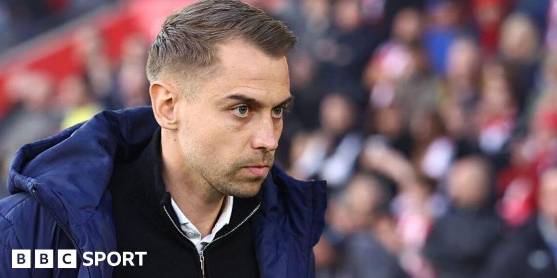 Southampton manager Tonda Eckert in blue coat and black zip-up top