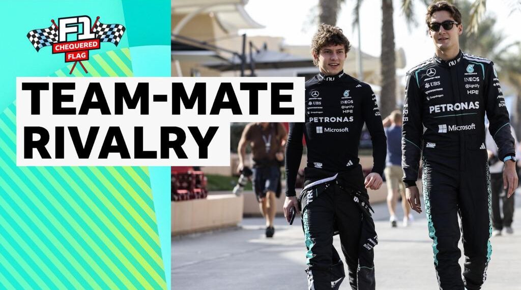 Kimi Antonelli and George Russell walking together dressed in Mercedes race suit