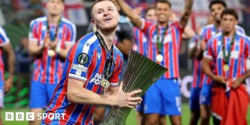 Adam Wharton celebrates with Conference League trophy