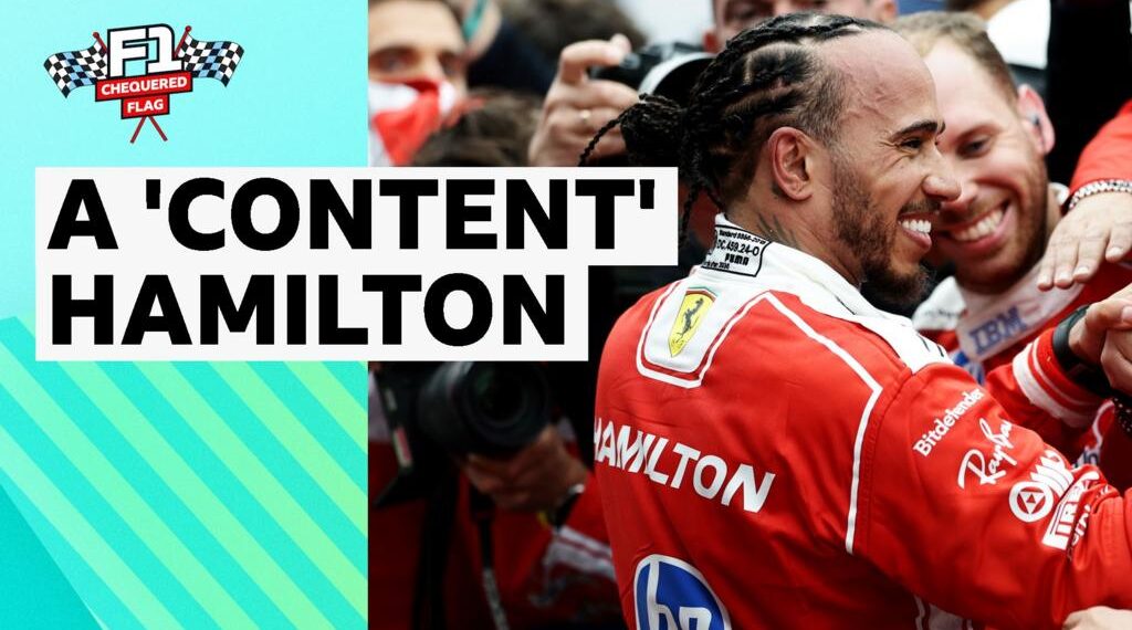Lewis Hamilton smiling in Ferrari race suit