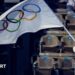 IOC president Kirsty Coventry waving an Olympic flag