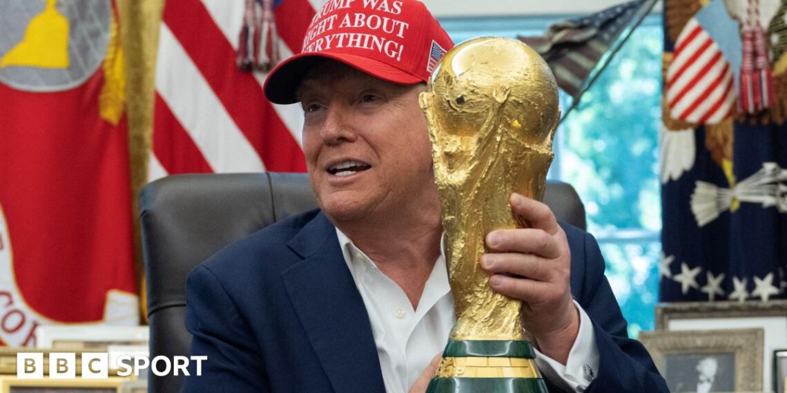 US President Donald Trump holding the World Cup trophy