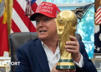 US President Donald Trump holding the World Cup trophy