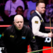 John Higgins eyes a shot