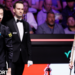 Wu Yize and Mark Allen assess a shot