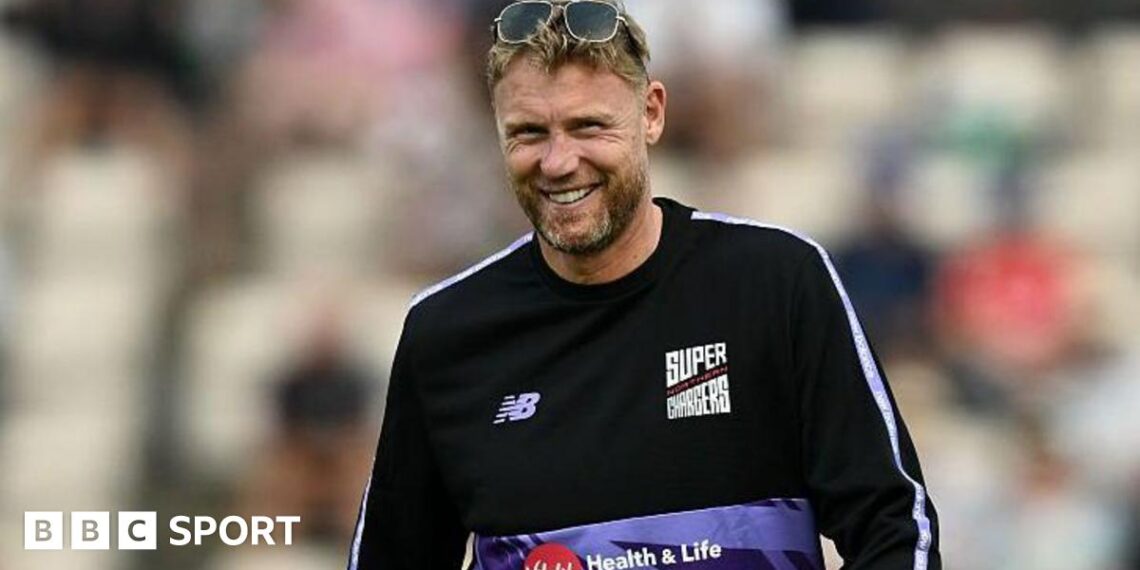 Andrew Flintoff smiling while wearing a Northern Superchargers shirt and a pair of sunglasses on top of his head.