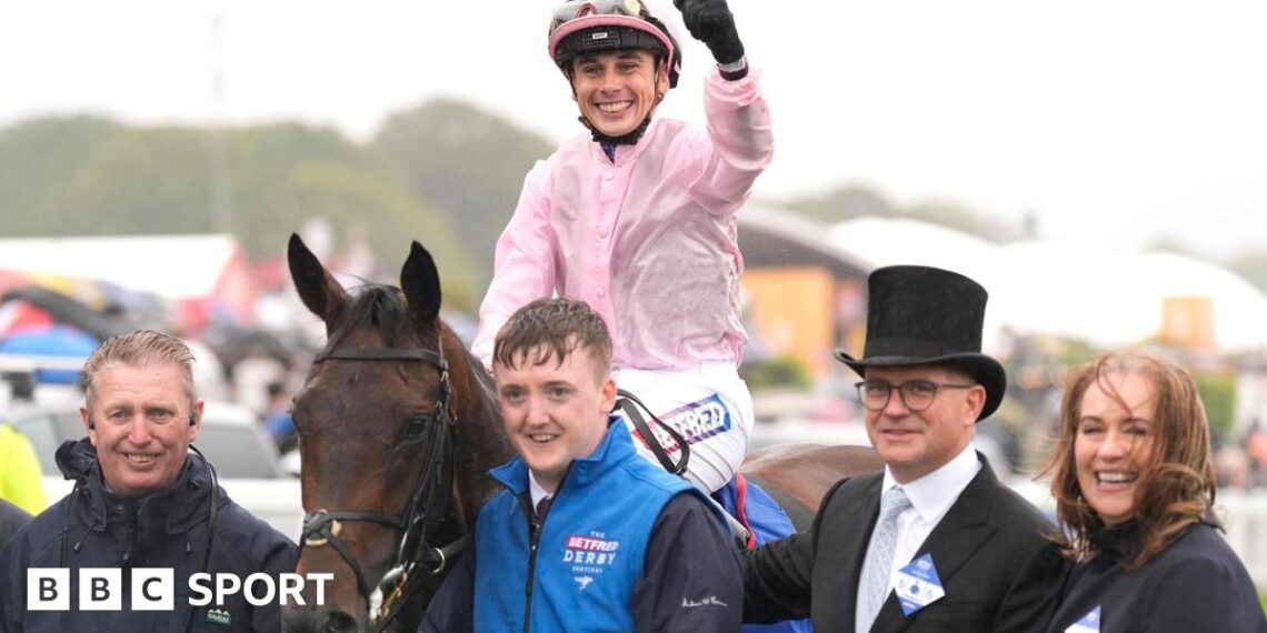 Jockey Ronan Whelan celebrates winning the Derby by punching the air while still saddling Christmas Day as he returns to the paddock