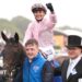 Jockey Ronan Whelan celebrates winning the Derby by punching the air while still saddling Christmas Day as he returns to the paddock