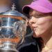 A close-up of Mirra Andreeva's jacket bearing the phrase 'I want to thank myself' while she holds the French Open winners' trophy