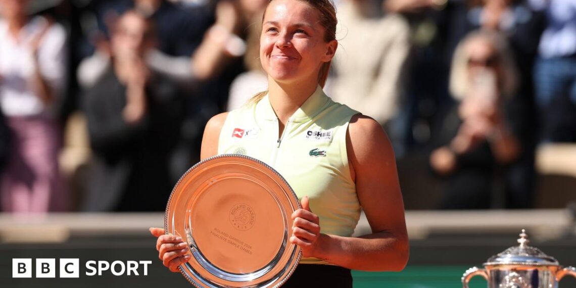 Maja Chwalinska smiles while holding the French Open women's singles runner-up trophy