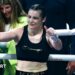 Katie Taylor holds up her thumbs as she stands in a boxing ring