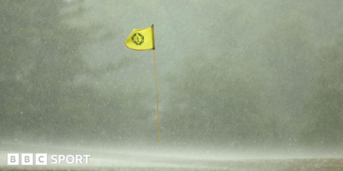 A flag billowing in the wind in heavy rain