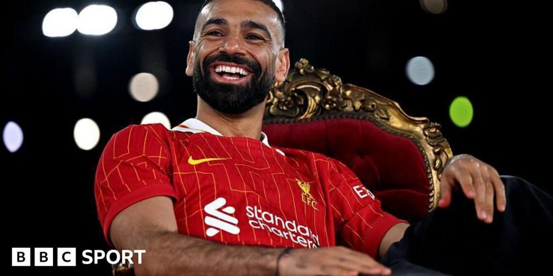 Egypt fans at the 2019 Africa Cup of Nations hold up a banner showing the face of forward Mohamed Salah