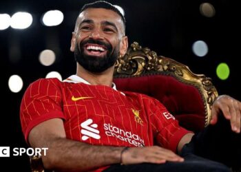 Egypt fans at the 2019 Africa Cup of Nations hold up a banner showing the face of forward Mohamed Salah