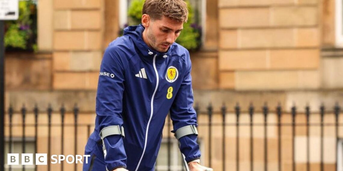 Scotland's Billy Gilmour leaves the team hotel on crutches