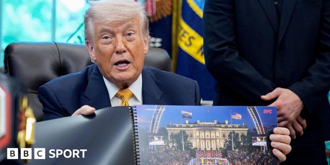 Donald Trump hols up a rendered image of the UFC's White House event