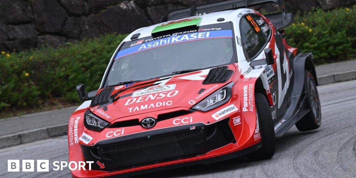 Elfyn Evans' red and white Toyota Yaris Rally1 car corners at Rally Japan