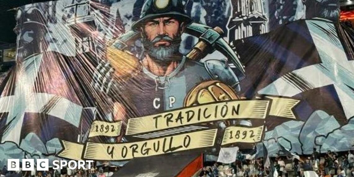 A tifo featuring a miner holding a pasty and a pickaxe