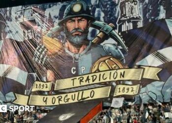 A tifo featuring a miner holding a pasty and a pickaxe
