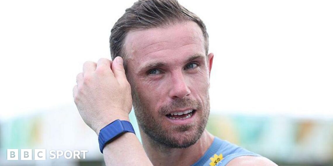 Jordan Henderson mops his brow during an England training session