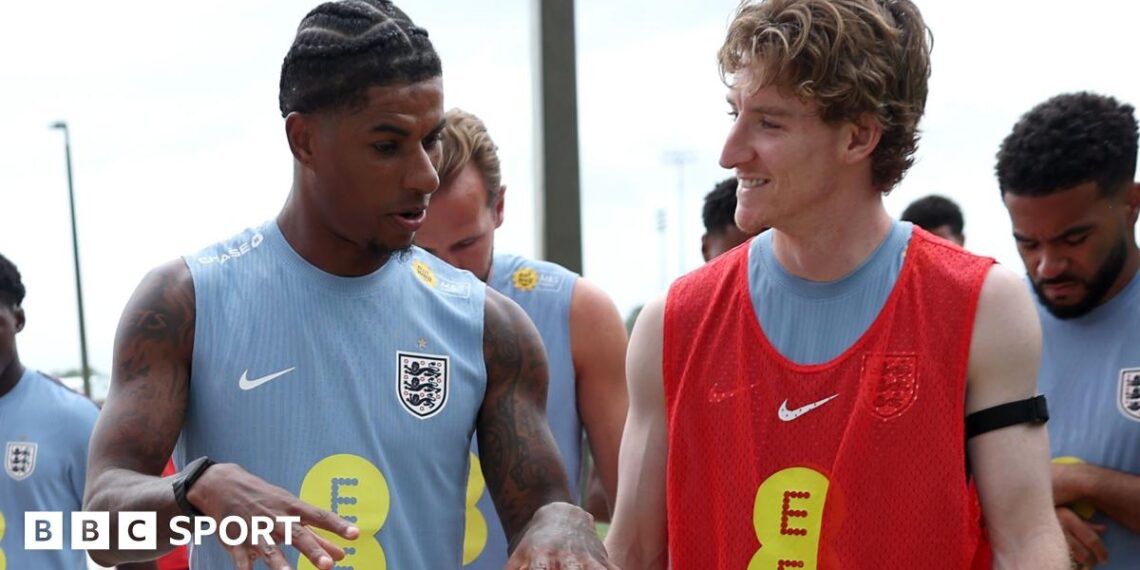Marcus Rashford and Anthony Gordon of England interact as they walk out for a training session