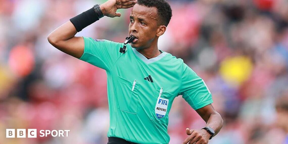 Omar Artan signalling for play to continue